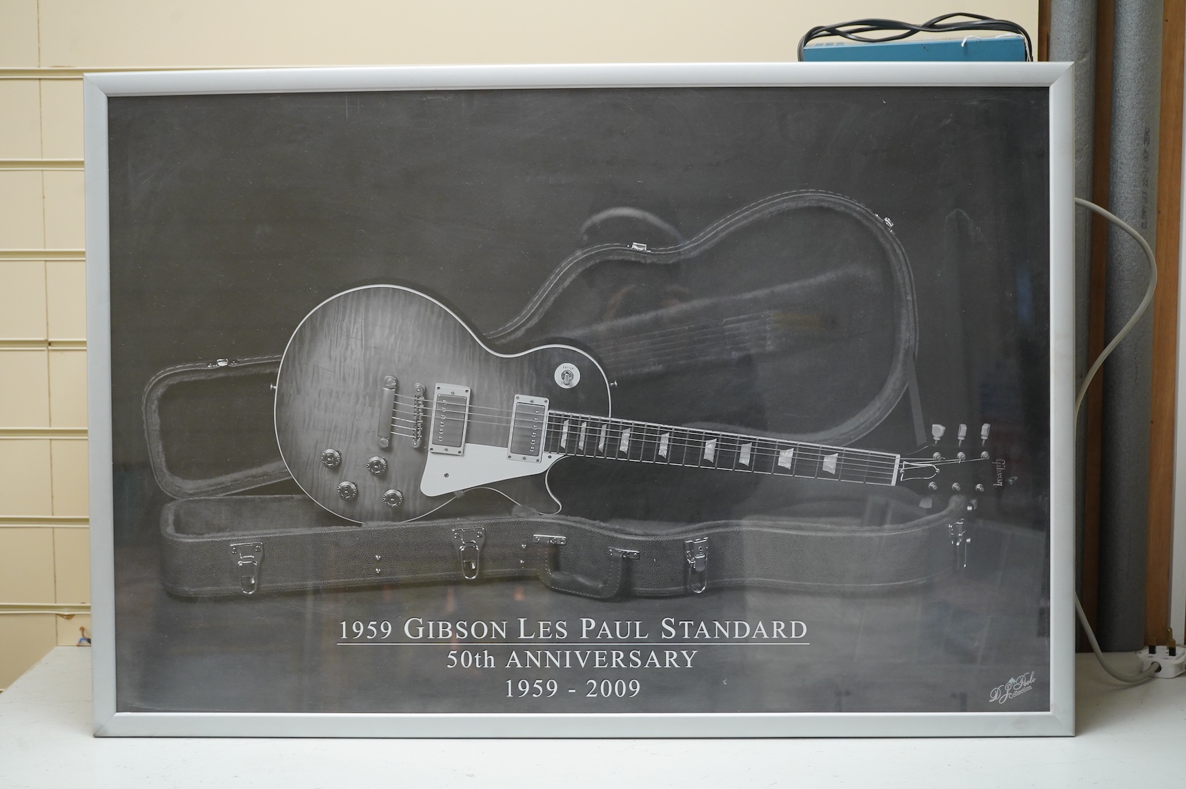 A limited edition 50th anniversary poster of the 1959 Gibson Les Paul standard guitar, 1959-2009, with certificate to the reverse limited edition 16/500, framed, 59 x 89cm